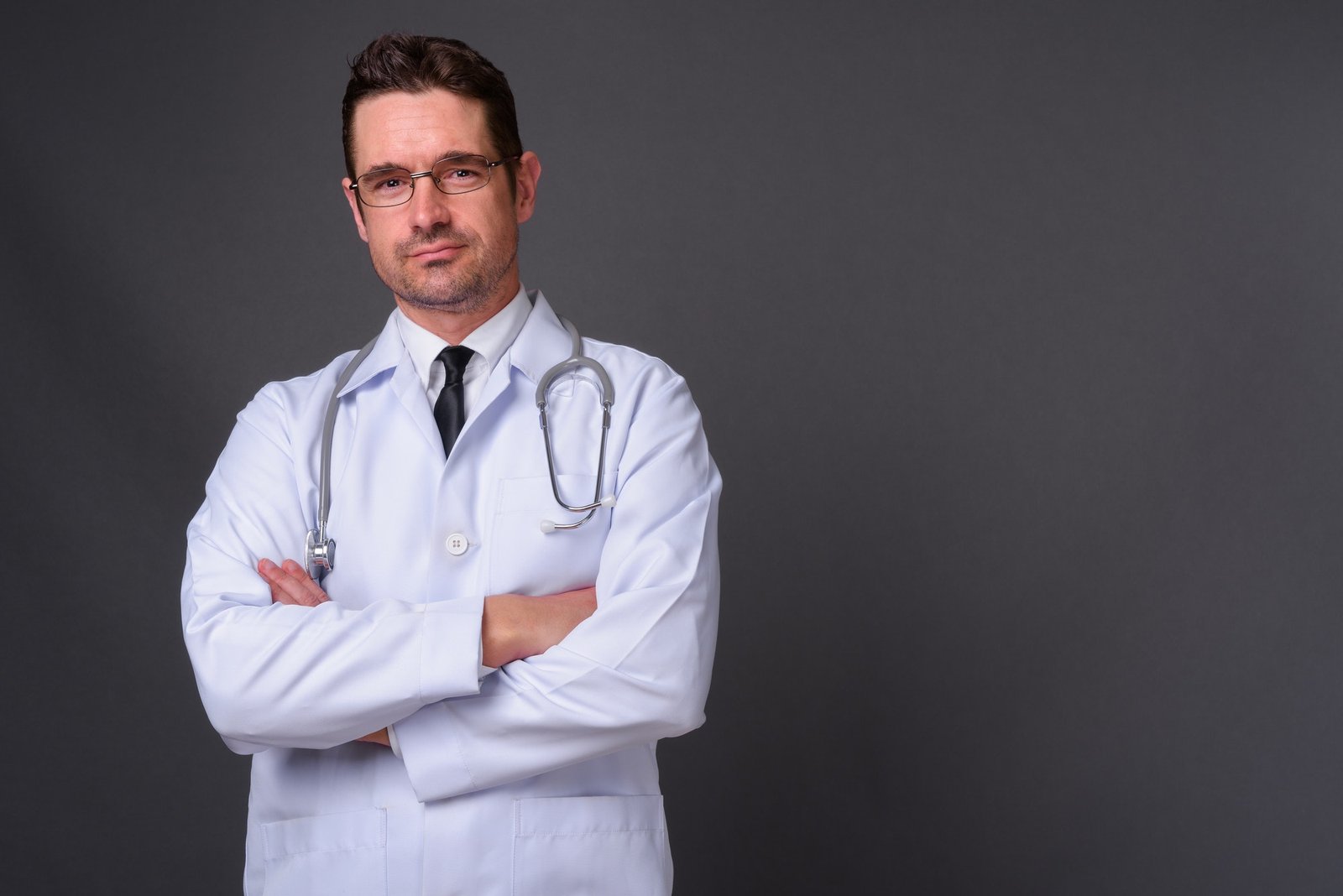 handsome-man-doctor-against-gray-background